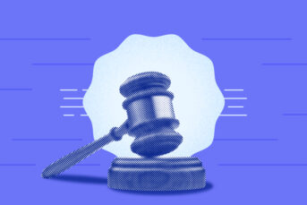 Gavel and block in front of a blue thing...