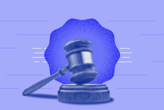 Gavel and block in front of a blue thing...